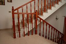 Wooden railing with barsindoorfor stair